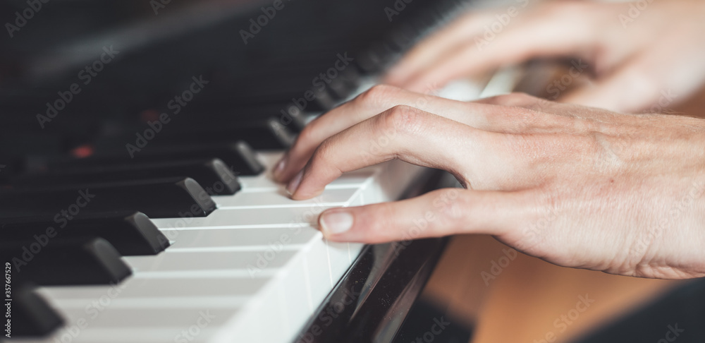 Obraz premium Playing piano at home, high angle view, blurry background.