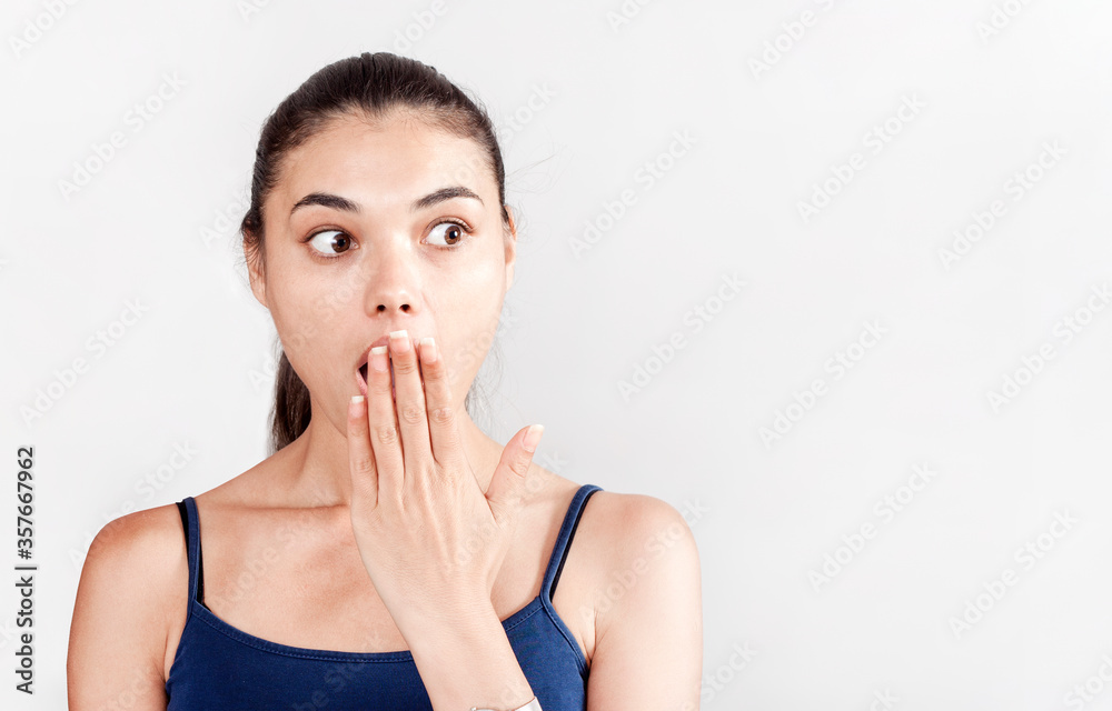 young woman covering her mouth with hands