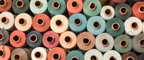 Threads in a tailor textile fabric: colorful cotton threads, birds eye perspective photo