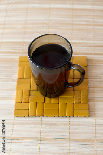 Mug with hot tea on the stand