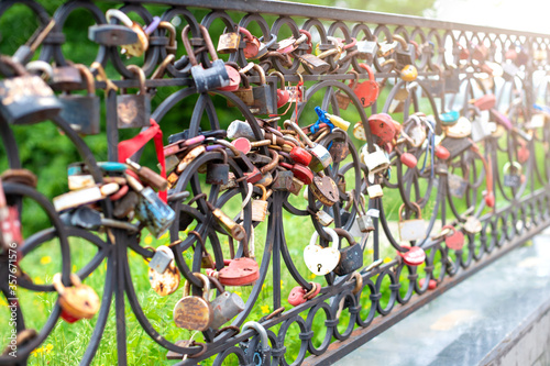 Many hanging iron locks on the fence from the newlyweds-a symbol and sign of a happy and long family life.