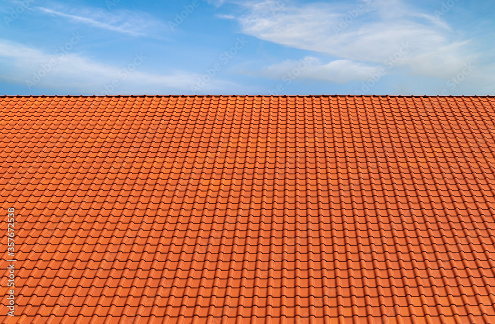 Terracotta roofing tile pattern blue sky white clouds background Terracotta roofing tile pattern blue sky white clouds background