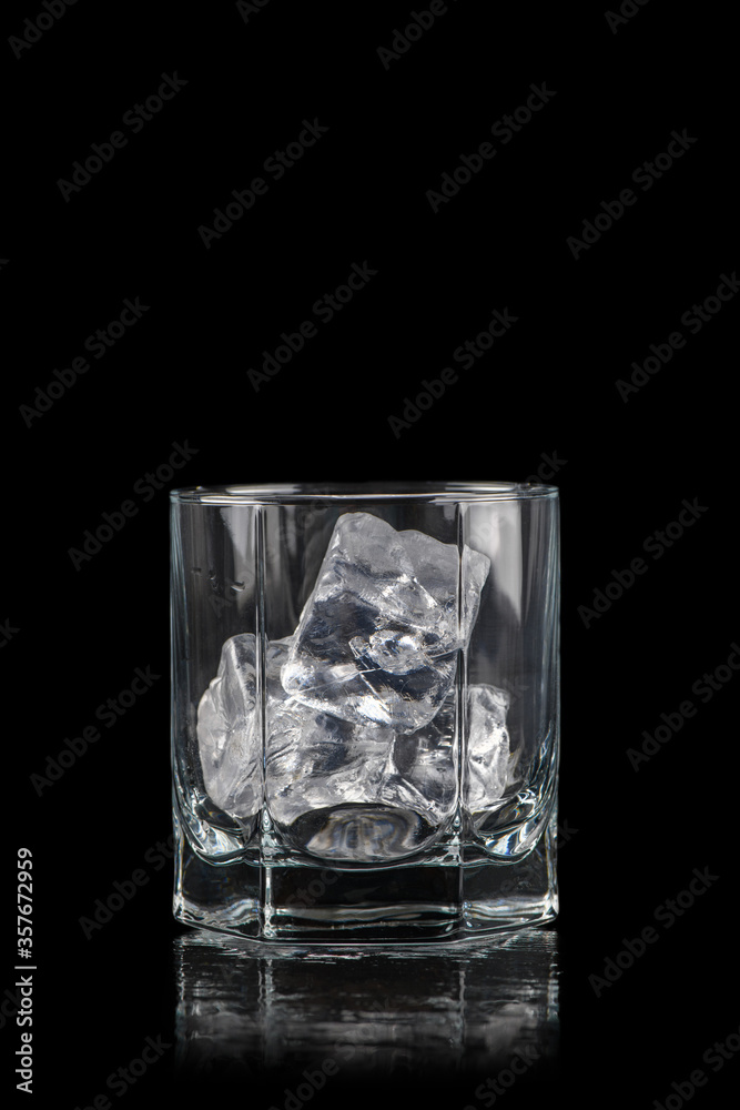Glass for alcoholic drinks with cun ice on black Glass for alcoholic drinks with cun ice on black