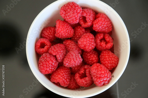 Photos Raspberries in bowl directly above view