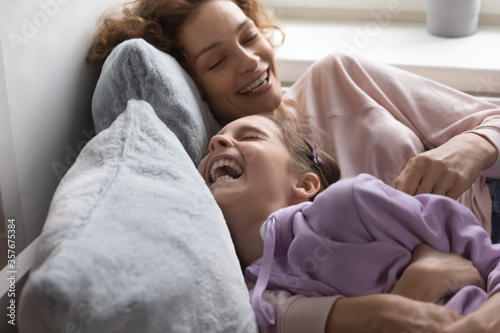 Photography Loving young Caucasian mother have fun play with smiling teenage daughter relaxi