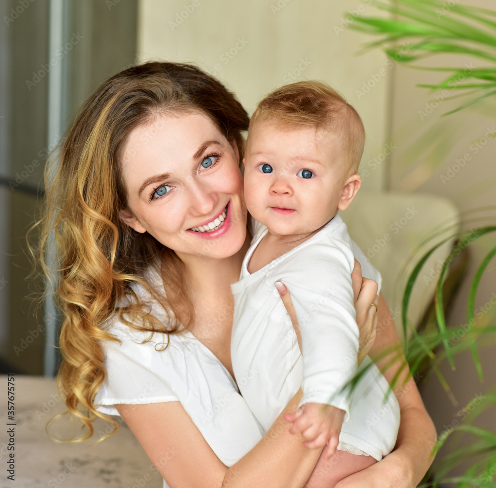 Mother and baby playing and smiling. Happy family.Home interior. Mother and baby playing and smiling. Happy family.Home interior.