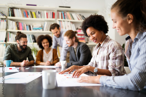 Cheerful coworkers in office during company meeting