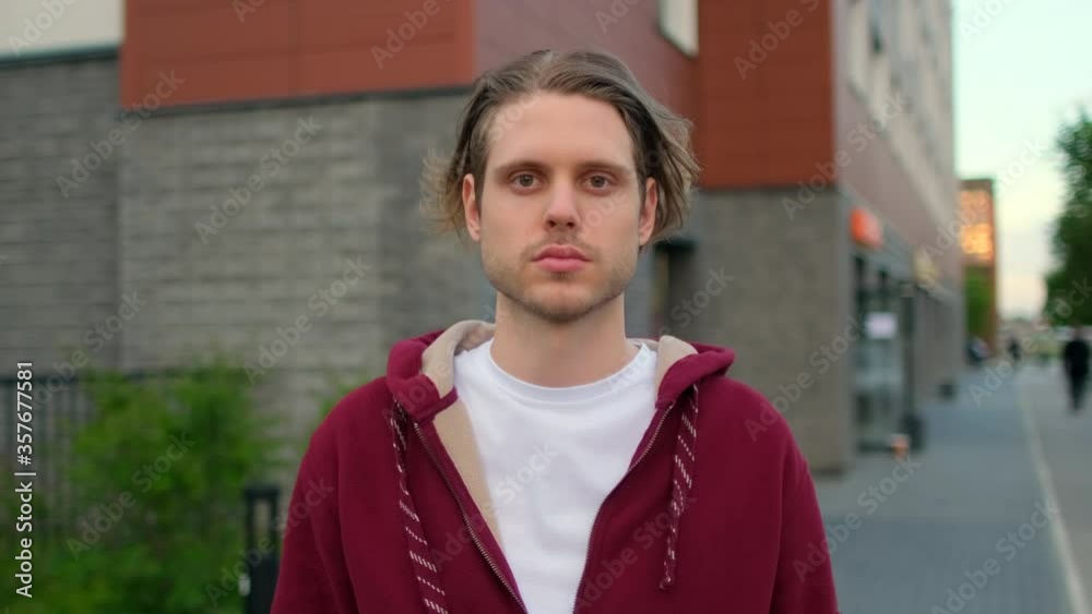 Close-up portrait of handsome young hipster man, guy standing outdoors street alone serious sad looking at camera, Beautiful people, student city lifestyle and urban emotions youth concept 4 K slow-mo Close-up portrait of handsome young hipster man, guy standing outdoors street alone serious sad looking at camera, Beautiful people, student city lifestyle and urban emotions youth concept 4 K slow-mo