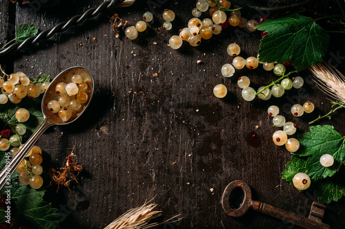 Table top view on a bunch of white currant on dark wooden table