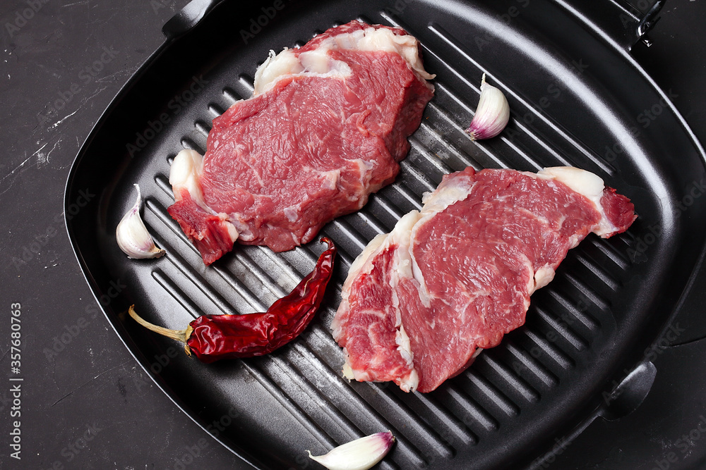 two steaks in a pan for grilling, macro two steaks in a pan for grilling, macro