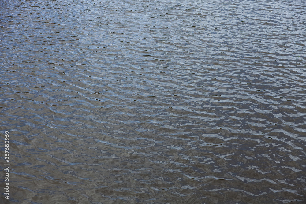 Small waves on the water. Ripple. Dark water. For the presentation of experiences. Small waves on the water. Ripple. Dark water. For the presentation of experiences.