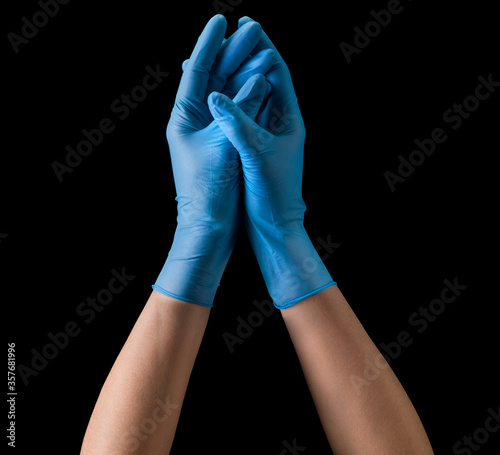 Doctor's hand in sterile medical gloves together symbolizing prayer isolated