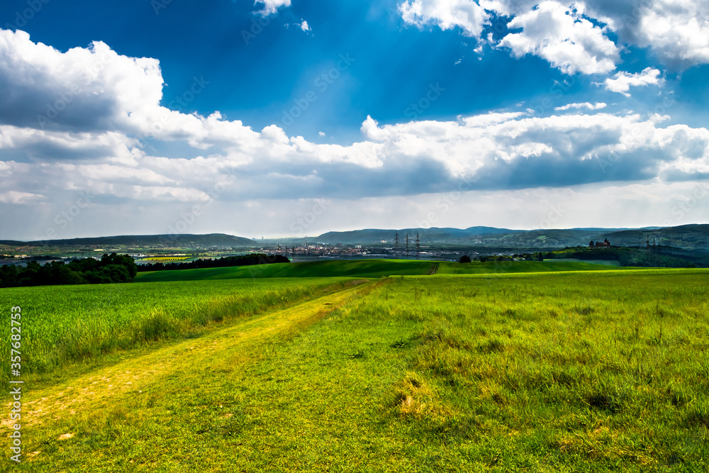 Rural Landscape With Sunlit Clouds In Front Of The Skyline Of Vienna In Austria Rural Landscape With Sunlit Clouds In Front Of The Skyline Of Vienna In Austria
