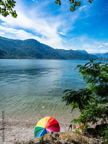 Relax on a beach of Lake Como after a trekking session © Nikokvfrmoto