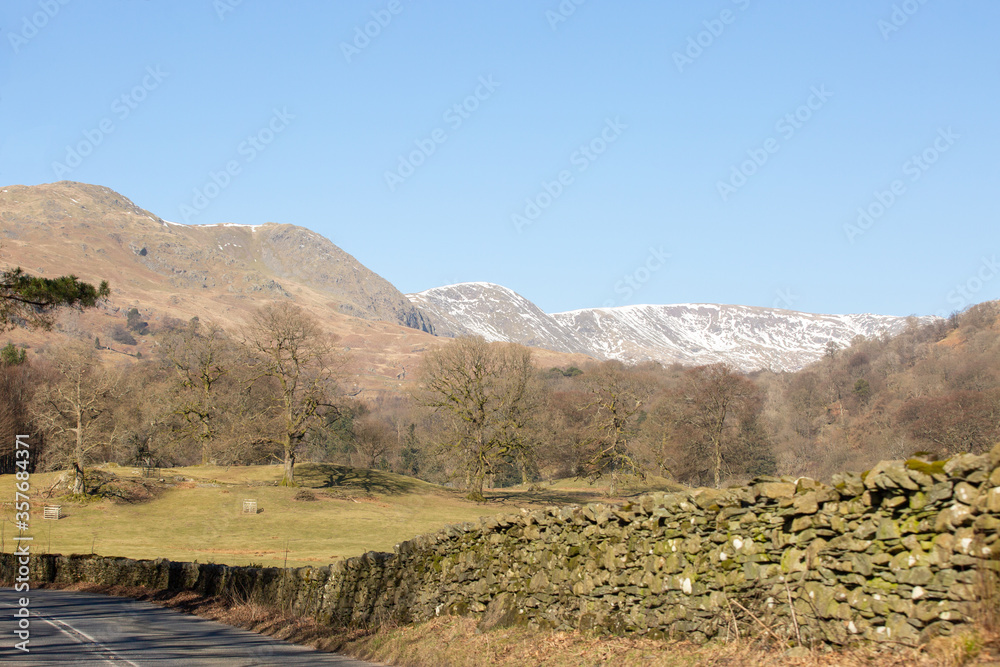 Road to Grasmere in the Lake District northern England with snowy mountain backdrop