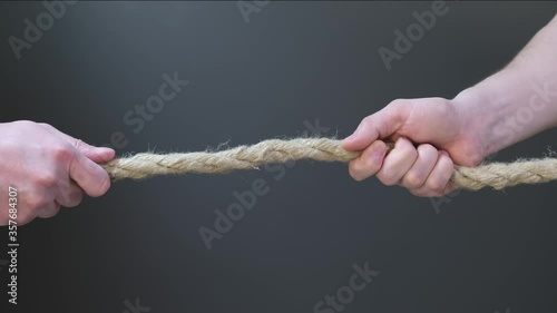 Two hand pull the rope on black background