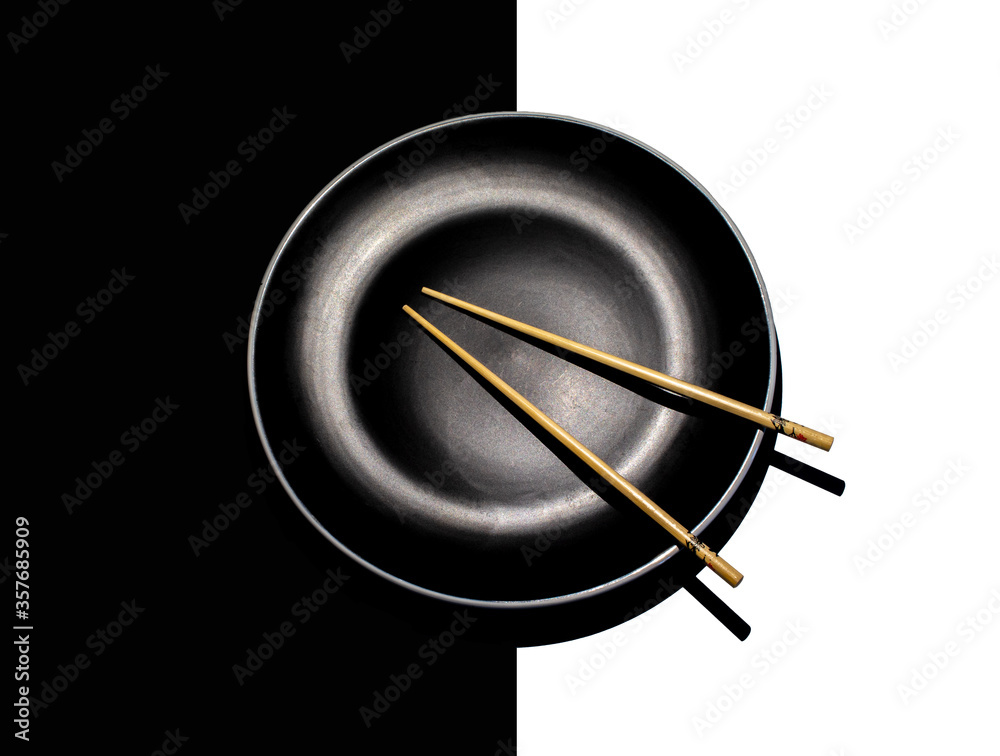 chopsticks on black plate and black and white background chopsticks on black plate and black and white background