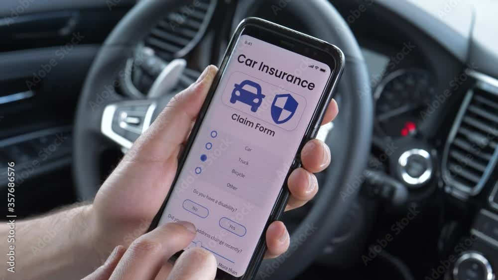 Using a smartphone mobile device to Fill up the insurance claim while sitting behind the wheel of a   vehicle car