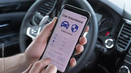 Using a smartphone mobile device to Fill up the insurance claim while sitting behind the wheel of a   vehicle car