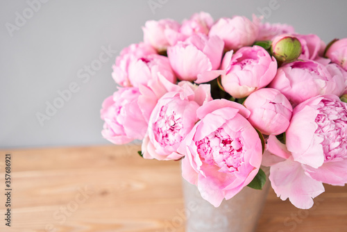 Pink Angel Cheeks peonies in a metal vase. Beautiful peony flower for catalog or online store. Floral shop concept . Beautiful fresh cut bouquet. Flowers delivery