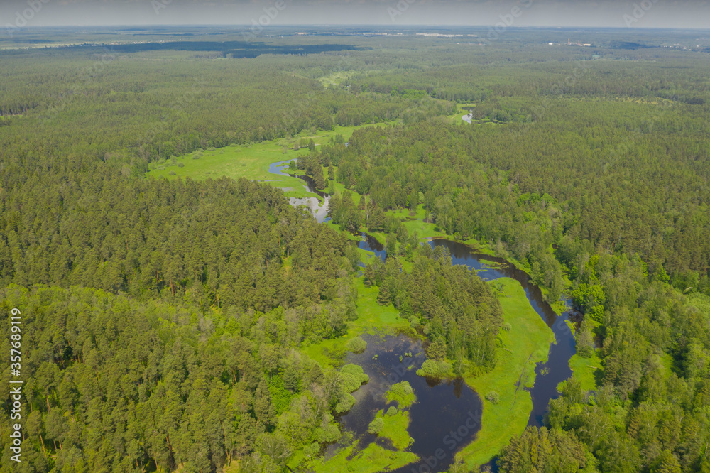 Flying above river in deep green forest, Moscow area, Russia