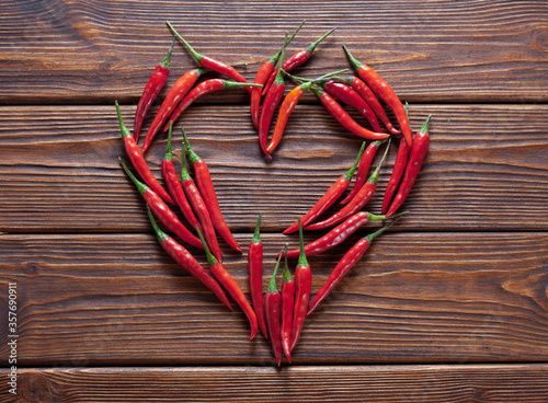 background of fresh red chili pepper arranged into heart shape for love