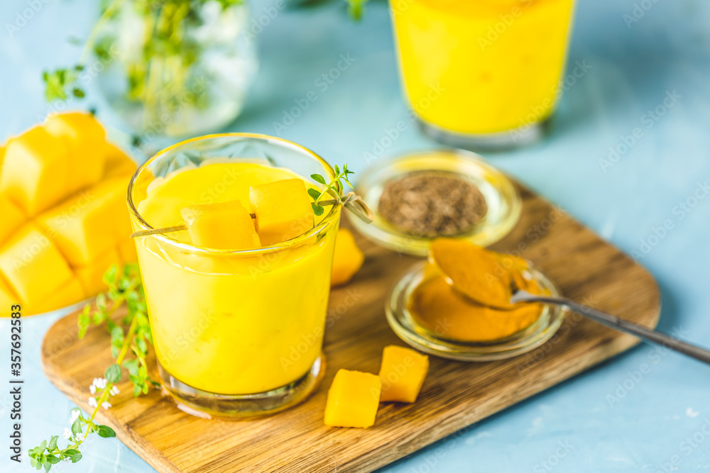 Yellow Indian mango yogurt drink Mango Lassi or smoothie with turmeric and saffron. Healthy