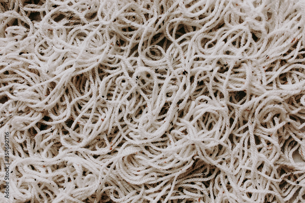 Tangled macrame cord heap on grey background Tangled macrame cord heap on grey background