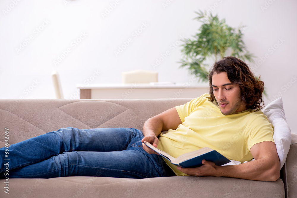 Young male student preparing for exams at home