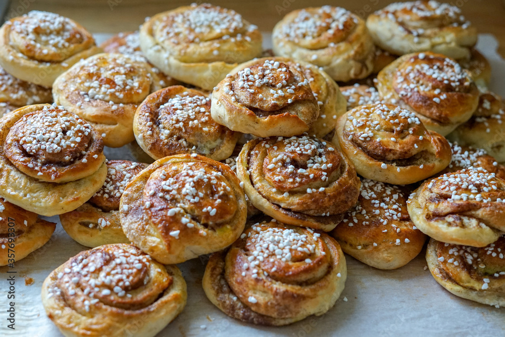 Batch of freshly baked homemade Swedish style cinnamon rolls / buns with pearl sugar -Image