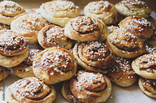 Batch of freshly baked homemade Swedish style cinnamon rolls / buns with pearl sugar -Image © DBER