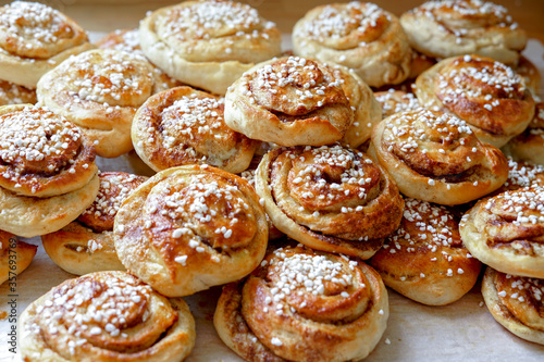 Batch of freshly baked homemade Swedish style cinnamon rolls / buns with pearl sugar -Image