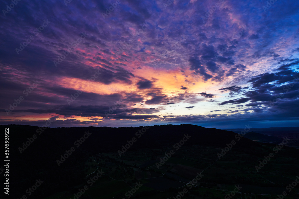 dramatic and colorful sky after sunset on the swabian alb