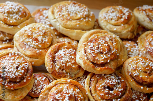 Batch of freshly baked homemade Swedish style cinnamon rolls / buns with pearl sugar -Image