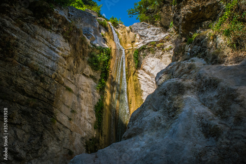 Small waterfall running through large rocks in Lefkada, Greece