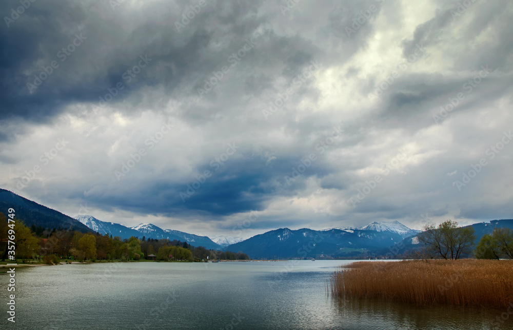 Clouds over the lake Tegernsee and the Bavarian Alps, beautiful landscape with mountains, water and sky in the famous tourist resort, Bavaria, Germany, Europe, copy space