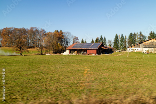 Farming lands and buildings with solar panels on the roof, Austria.