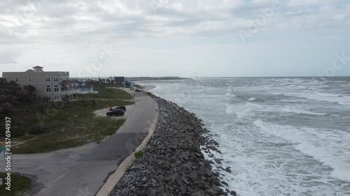 Zooming out over the rocky shoreline of the coast