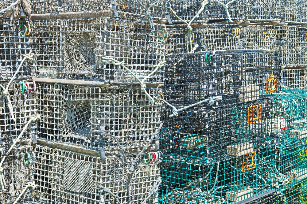 A stack of lobster traps, also known as lobster pots, near a fishing port in Massachusetts.