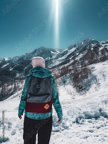 Girl looks into the distance at the mountains
