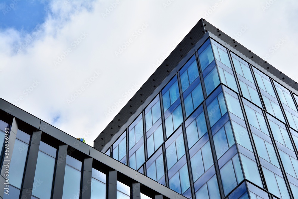 Facade texture of a glass mirrored office building. Fragment of the facade. Modern architecture of the office building. Facade texture of a glass mirrored office building. Fragment of the facade. Modern architecture of the office building.