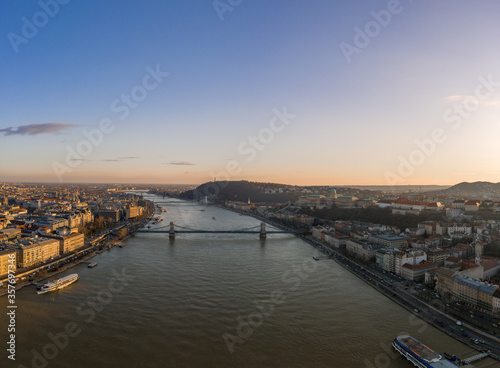 Aerial drone shot of Danube river with chain bridge and Buda Castle in Budapest in Sunset hour