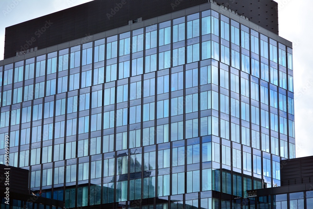 Facade texture of a glass mirrored office building. Fragment of the facade. Modern architecture of the office building. Facade texture of a glass mirrored office building. Fragment of the facade. Modern architecture of the office building.