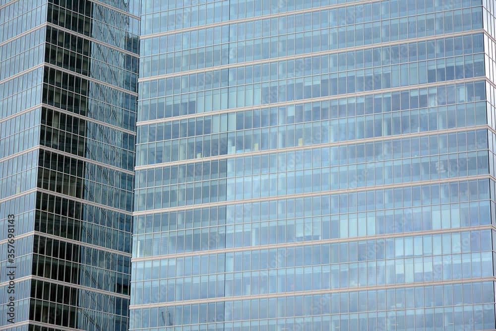 Facade texture of a glass mirrored office building. Fragment of the facade. Modern architecture of the office building.