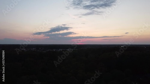 Beautiful sunset over a neighborhood as the camera pans up to reveal the homes