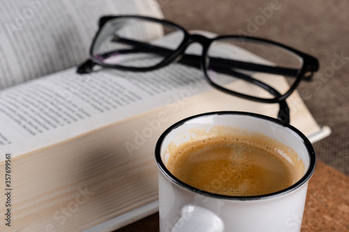 cup of coffee with book and glasses 
