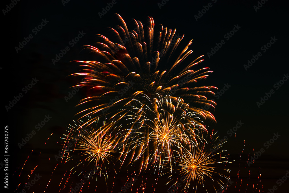 Festive fireworks in the sky for a holiday. Bright multi-colored salute on a black background. Place for text. Festive fireworks in the sky for a holiday. Bright multi-colored salute on a black background. Place for text.