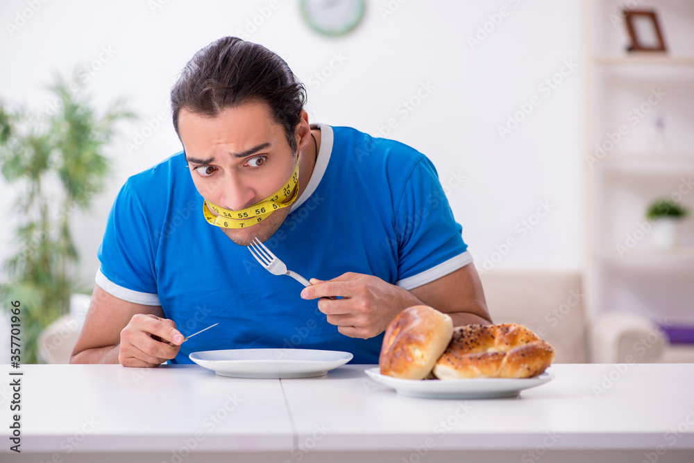 Young hungry man in dieting concept Young hungry man in dieting concept