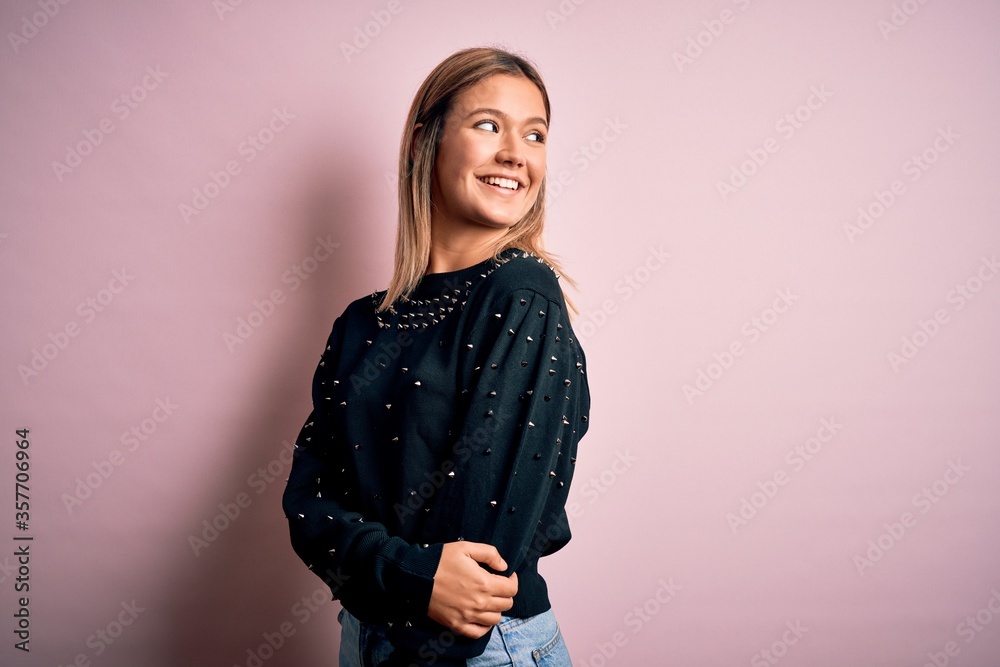 Young beautiful woman wearing fashion urban clothes, model wearing casual street style standing over pink background Young beautiful woman wearing fashion urban clothes, model wearing casual street style standing over pink background