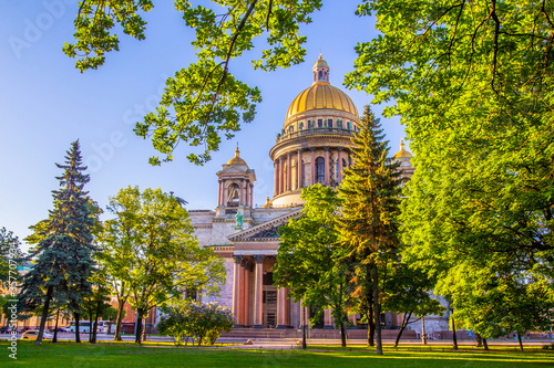 Saint Petersburg. Russia. St. Isaac's Cathedral. Trees on the background of the cathedral. City landscape. Excursions to St. Isaac's Cathedral. Traveling to the cities of Russia. Petersburg summer